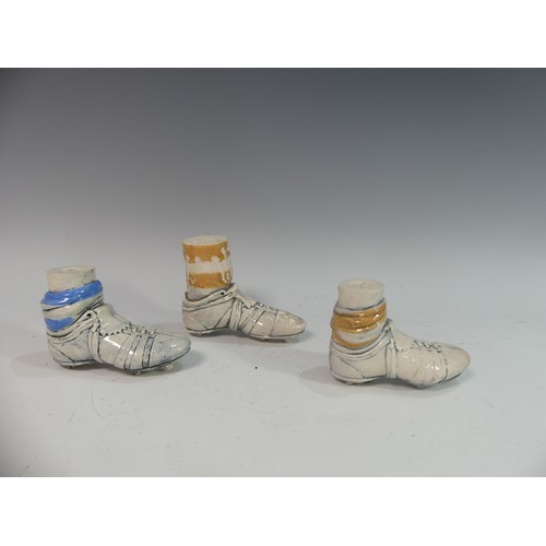 90 - Lawson E. Rudge (b. 1936), a pair of studio pottery football boot Salt and Pepper Pots, in the form ... 