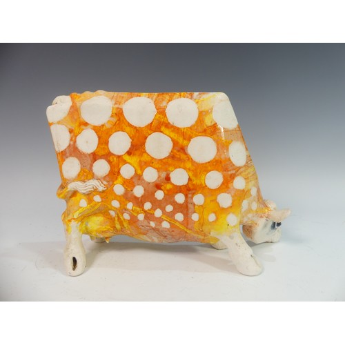 110 - Lawson E. Rudge (b. 1936), a studio pottery sculpture of a Grazing Cow, with orange glazed hare deco... 