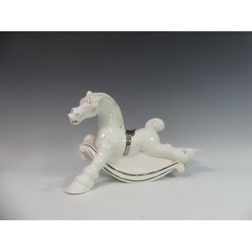 114 - Lawson E. Rudge (b. 1936), a white glazed studio pottery sculpture Carousel Horse, hairline crack to... 