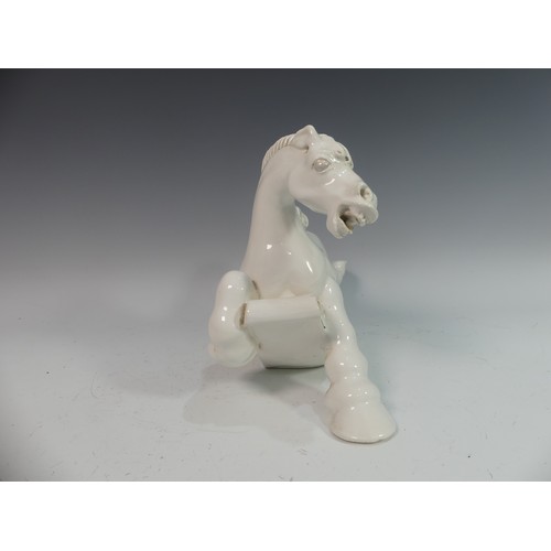 114 - Lawson E. Rudge (b. 1936), a white glazed studio pottery sculpture Carousel Horse, hairline crack to... 