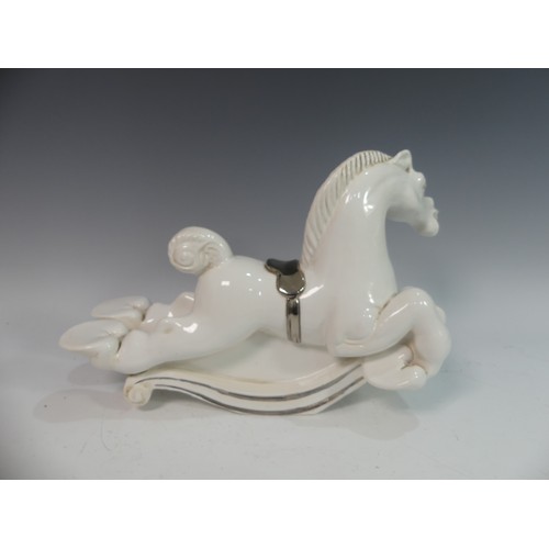 114 - Lawson E. Rudge (b. 1936), a white glazed studio pottery sculpture Carousel Horse, hairline crack to... 