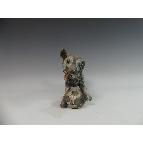 116 - Lawson E. Rudge (b. 1936), a raku fired studio pottery sculpture of a Border Collie, modelled playin... 