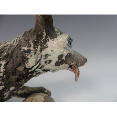 116 - Lawson E. Rudge (b. 1936), a raku fired studio pottery sculpture of a Border Collie, modelled playin... 