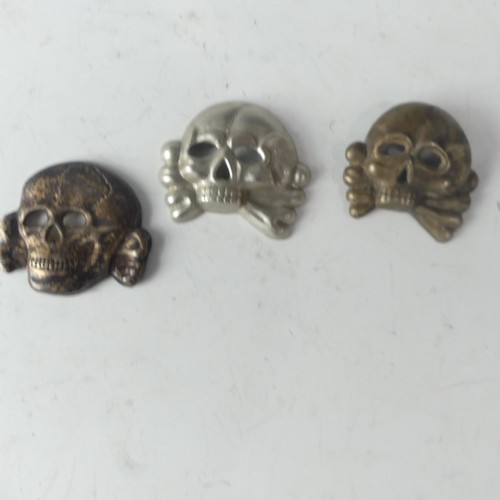 379 - A collection of five German WW2 period SS Cap Badge, three skulls, two eagles, together with an SS O... 