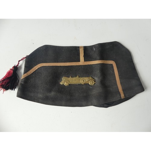 397 - A German WW2 period armband, together with a British WW2 Forage cap with 'car' badge and tassel and ... 