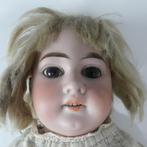 211 - An Armand Marseille bisque shoulder head doll,  with fixed brown glass eyes, open mouth, with top te... 