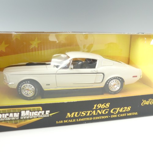 215 - A 1968 1:18 scale model of a Mustang CJ428, white with black stripe, boxed, together with a 1969 Pon... 