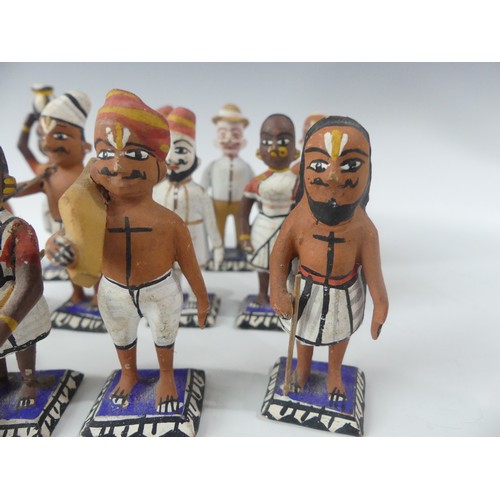 240 - A collection of vintage Indian painted carved wood figures, in a variety of types and traditional co... 