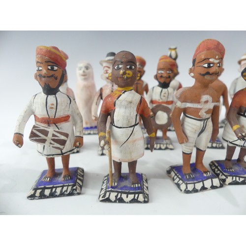 240 - A collection of vintage Indian painted carved wood figures, in a variety of types and traditional co... 