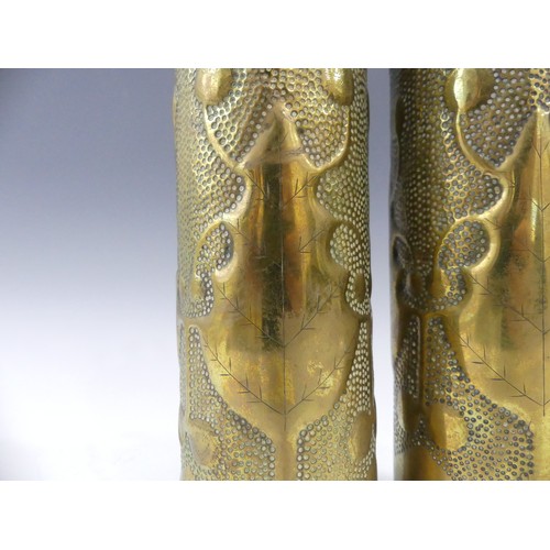 435 - A pair of Trench Art embossed vases, engraved to bottom 