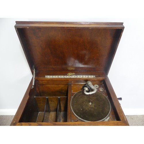 571 - An early 20thC oak cased Selecta Gramophone, having a lift-up lid, record storage and door opening t... 