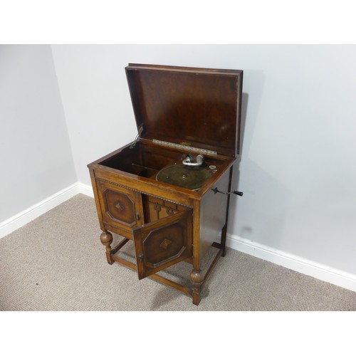 571 - An early 20thC oak cased Selecta Gramophone, having a lift-up lid, record storage and door opening t... 