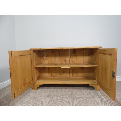 574 - A vintage pine Dresser Base, with double cupboard doors opening to reveal a single shelf, on bracket... 