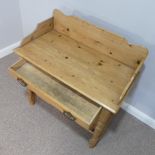 594 - An early 20thC pine Wash Stand, with gallery back above a single frieze drawer and undertier, raised... 