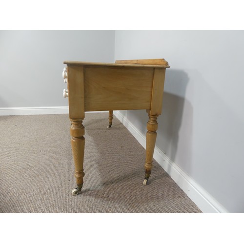 605 - An early 20thC pine Wash Stand, with gallery back, above one long and four short drawers all with ce... 