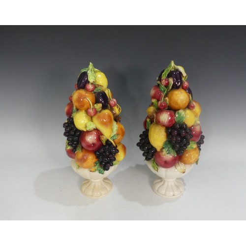 502 - A pair of Capodimonte porcelain Fruit Centrepieces, modelled in vases, some losses, factory marks to... 