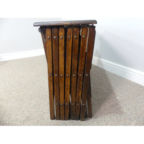 614 - An early 20thC oak-framed concertina camp bed, W 70cm x H 49cm x L 200cm