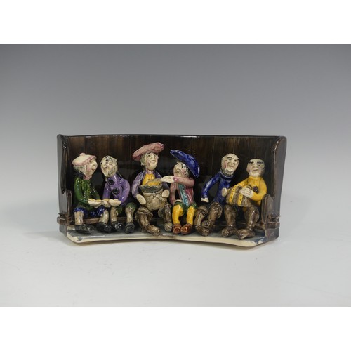 510 - A Will Young for Runnaford Pottery Widecombe Fair Group, modelled seated on a settle, signed to unde... 