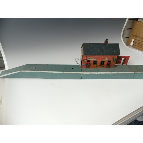 296 - A vintage Bing printed tinplate Station building and platform, incomplete, 124cm long, together with... 