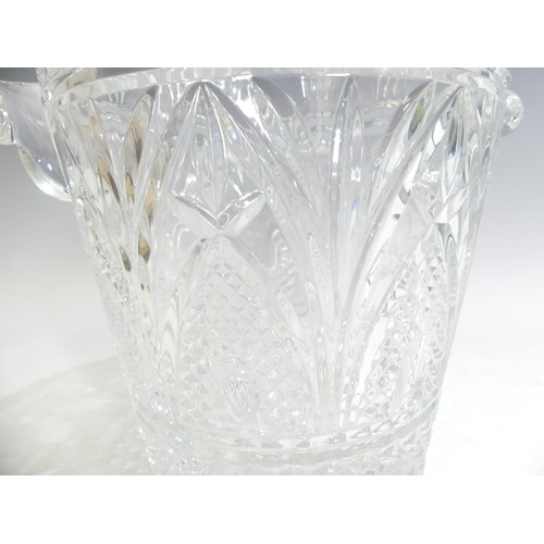 516 - A cut lead crystal glass Champagne Bucket, having shaped twin handles with star cut, hobnail and fac... 