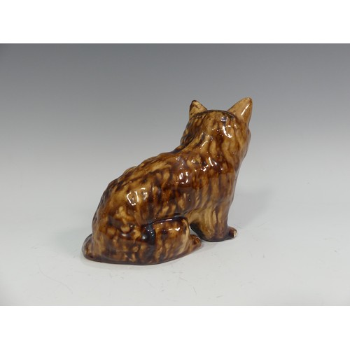 525 - A rare late 18th/early 19thC treacle glazed Money Box, in the form of a lion, head broken and repair... 