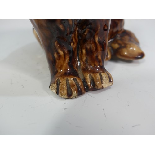 525 - A rare late 18th/early 19thC treacle glazed Money Box, in the form of a lion, head broken and repair... 