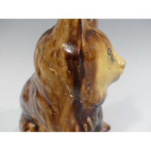 525 - A rare late 18th/early 19thC treacle glazed Money Box, in the form of a lion, head broken and repair... 