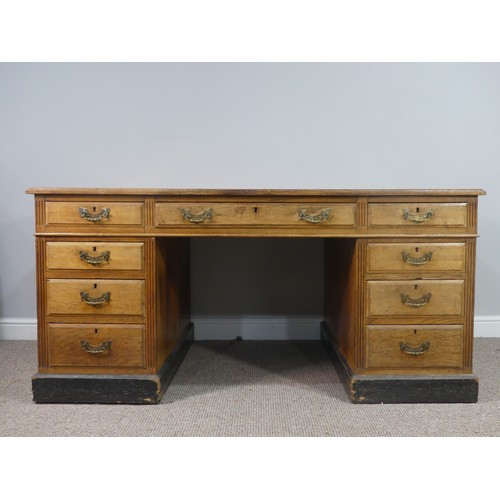 639 - An Edwardian oak twin Pedestal Desk, the tooled leather top above three frieze drawers with three fu... 