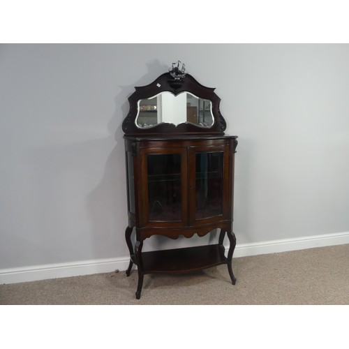 641 - An Edwardian mahogany bow-front mirrored Display Cabinet, with shelved interior and shaped under tie... 