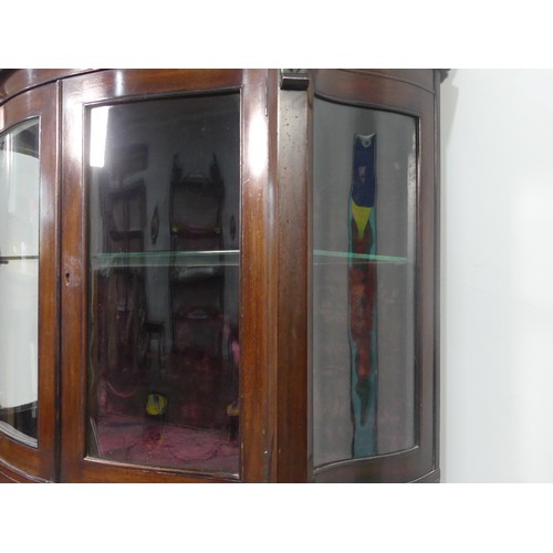 641 - An Edwardian mahogany bow-front mirrored Display Cabinet, with shelved interior and shaped under tie... 