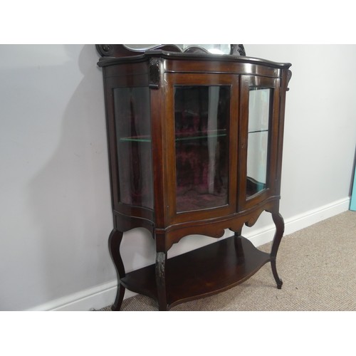 641 - An Edwardian mahogany bow-front mirrored Display Cabinet, with shelved interior and shaped under tie... 