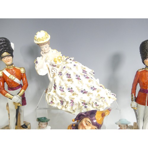 491 - A Capodimonte style porcelain figure of a Napoleonic Soldier, modelled on a stepped plinth with Crow... 