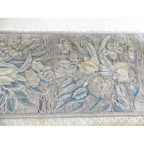 647 - An antique tapestry and fabric upholstered long Stool, fading, holes and watermarks to covering, W 1... 