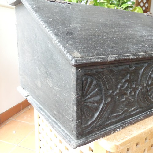 652 - An 18th century oak Bible Box, the sloped lid above a carved frieze, some scuffs, wear and damage to... 