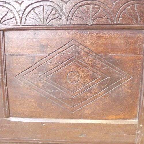 653 - An 18th century oak Coffer, the two-panel front with carved decoration, on square feet, with replace... 