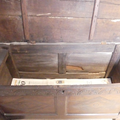 653 - An 18th century oak Coffer, the two-panel front with carved decoration, on square feet, with replace... 