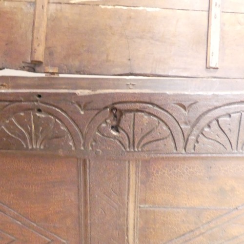 653 - An 18th century oak Coffer, the two-panel front with carved decoration, on square feet, with replace... 