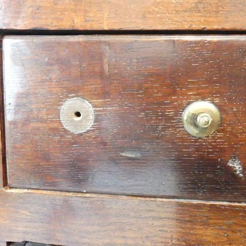 656 - A Georgian oak Dresser, having a three-tier plate rack above six drawers and two cupboards, one hand... 