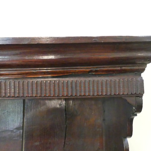 656 - A Georgian oak Dresser, having a three-tier plate rack above six drawers and two cupboards, one hand... 