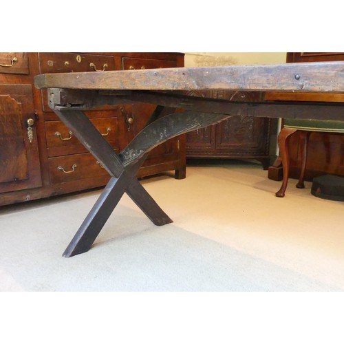 657 - A Georgian oak Refectory Table, the rectangular top above stile feet joined by a stretcher, stretche... 