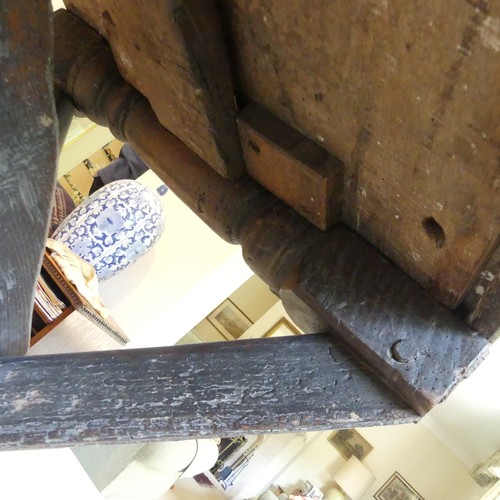 657 - A Georgian oak Refectory Table, the rectangular top above stile feet joined by a stretcher, stretche... 