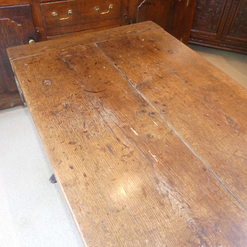 657 - A Georgian oak Refectory Table, the rectangular top above stile feet joined by a stretcher, stretche... 