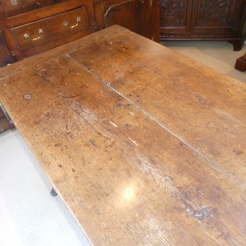 657 - A Georgian oak Refectory Table, the rectangular top above stile feet joined by a stretcher, stretche... 