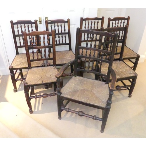 658 - A set of seven Georgian style Dining Chairs, with spindle back and rush seat, raised on turned legs ... 