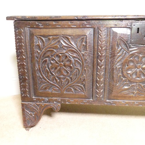 659 - An 18th century oak Coffer, with carved frieze and three carved panels, on stile feet, split to top ... 