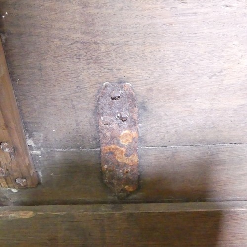 659 - An 18th century oak Coffer, with carved frieze and three carved panels, on stile feet, split to top ... 