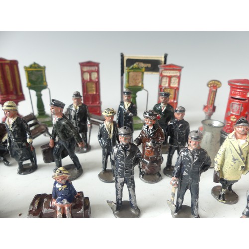 287 - A quantity of vintage '0' gauge lead station figures and accessories, including platform signs, vend... 