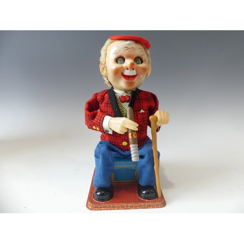 180 - A Vintage Tinplate Smoking McGregor Toy, in super condition, by Rosko Toys Japan.  In original box, ... 