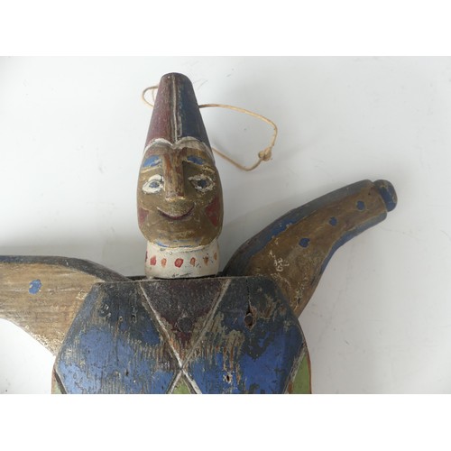 183 - A 19thC Folk Art carved pine and polychrome decorated Jumping Jack Toy, in the form of a Harlequin, ... 