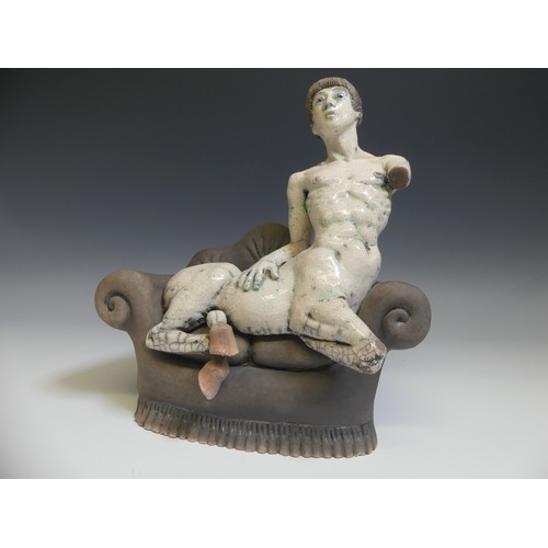 113 - Lawson E. Rudge (b. 1936), a raku fired studio pottery sculpture of a Centaur on Sofa, H 31cm.Proven... 